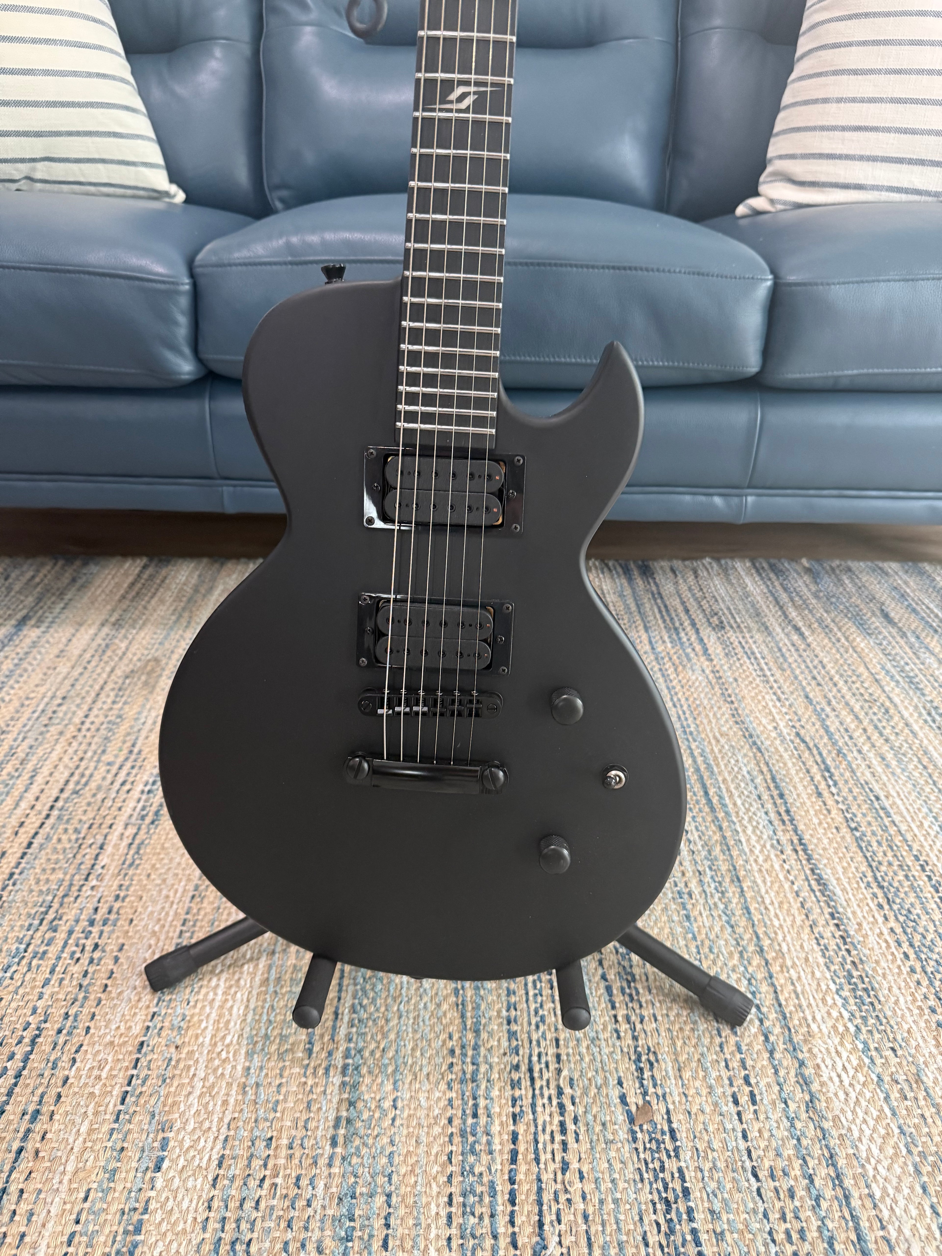 Palm Harbor Music Spira L-400 MBK electric guitar with black finish and sleek design.