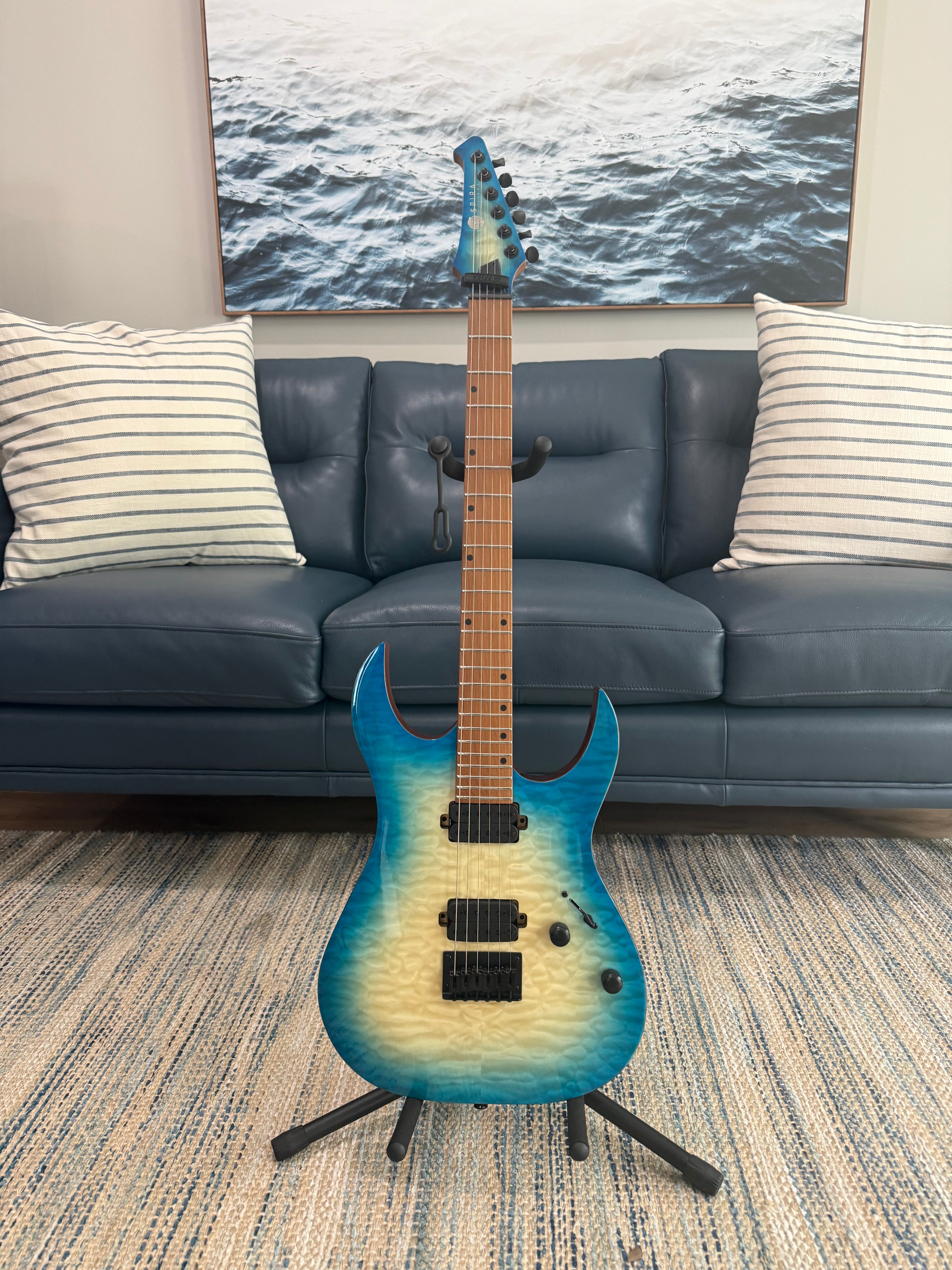 Palm Harbor Music Spira S-500 QAB acoustic guitar with a natural wood finish, showcasing the body and neck.