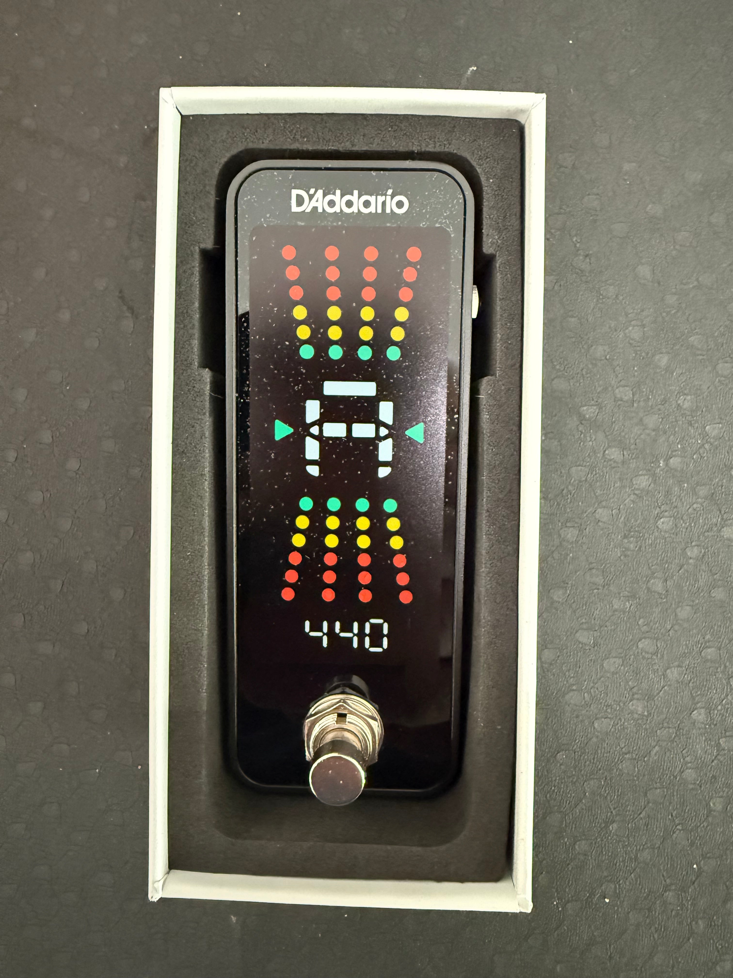 Chromatic pedal guitar tuner by Palm Harbor Music with display and footswitch for easy tuning adjustments.