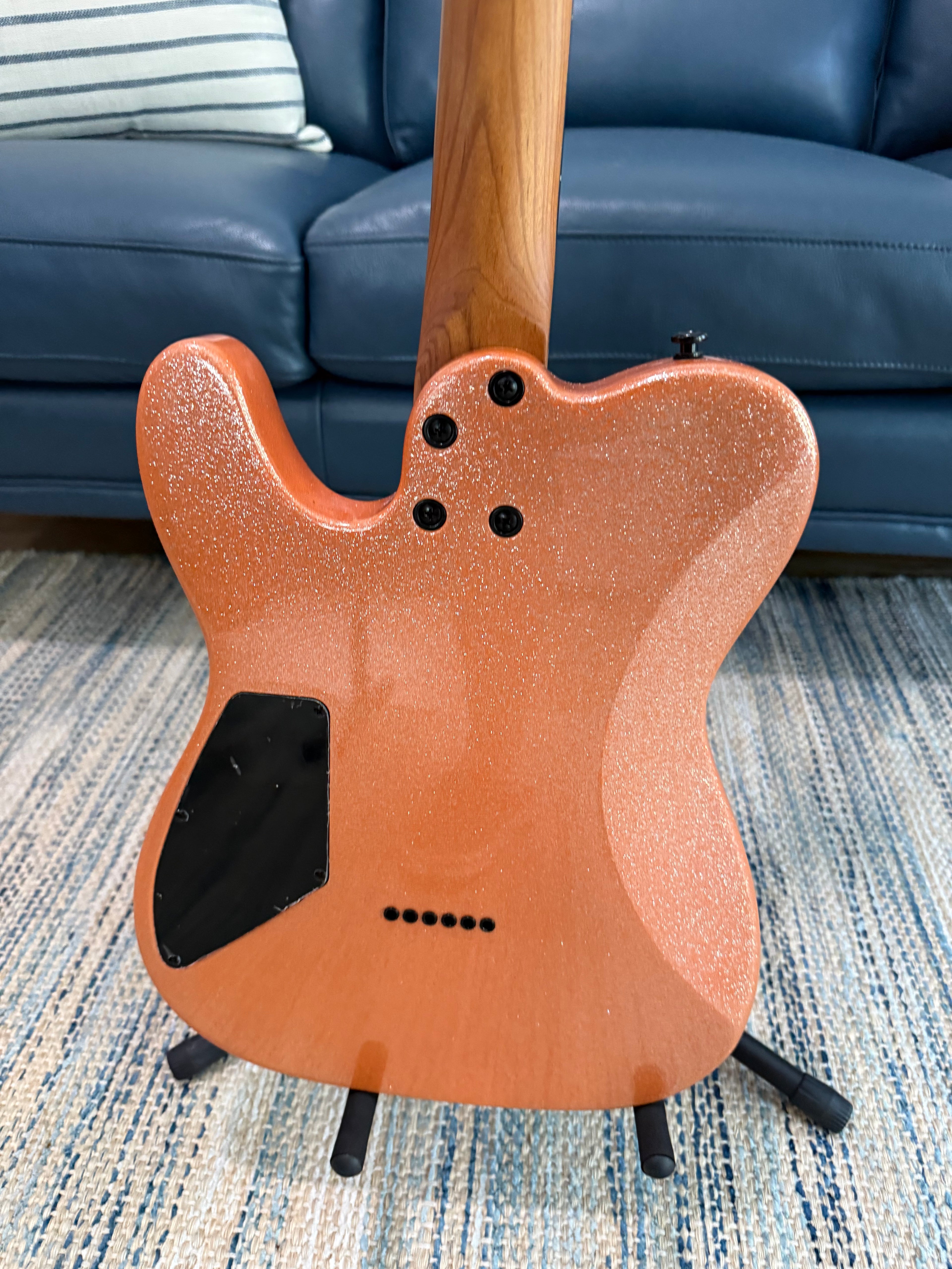Cerberus Hermes 6HT Baritone saxophone in orange sparkle finish, new, with detailed close-up of the instrument's body and keys.
