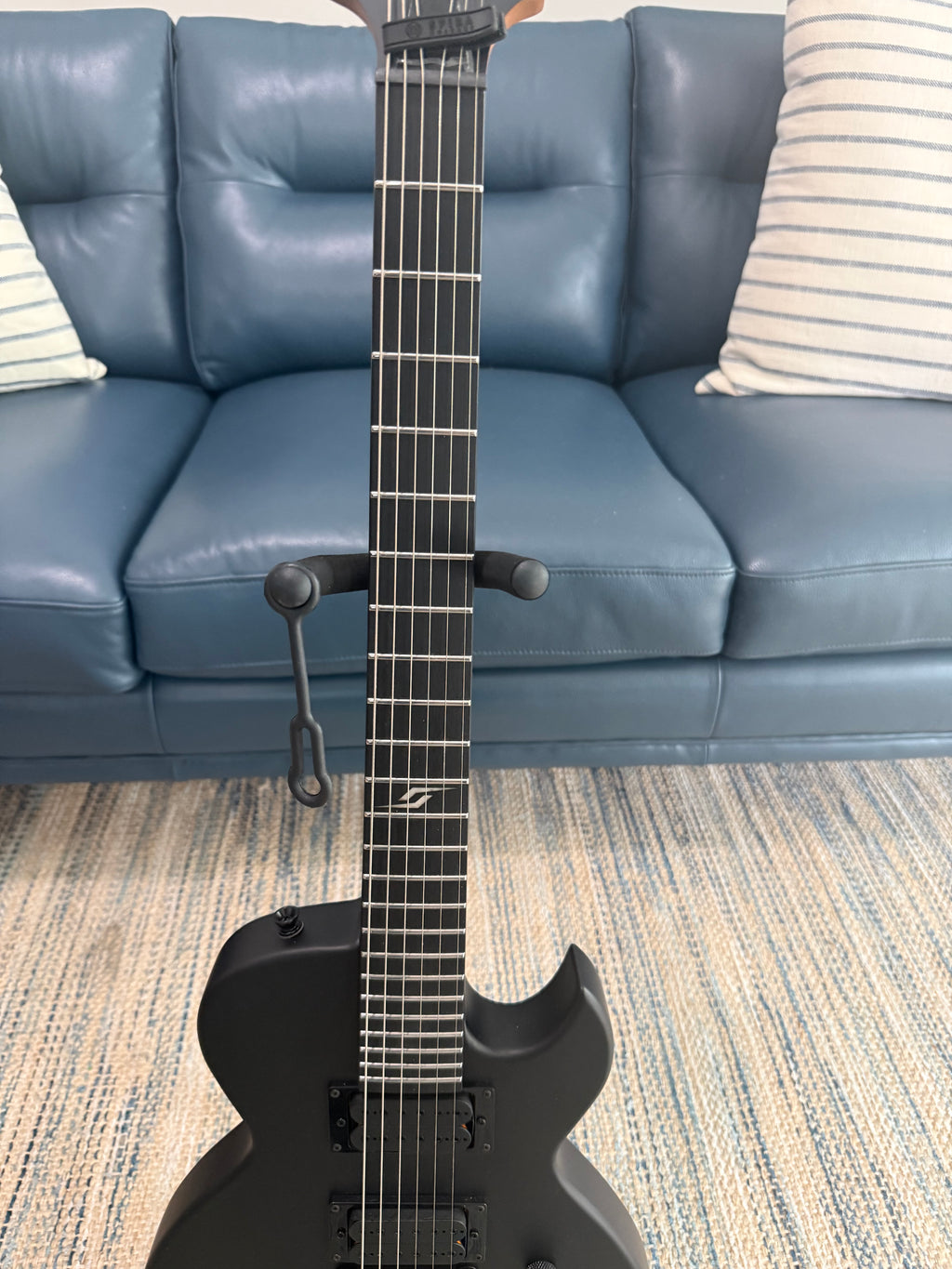 Palm Harbor Music Spira L-400 MBK guitar with dark wood finish and six strings, displayed against a plain background.