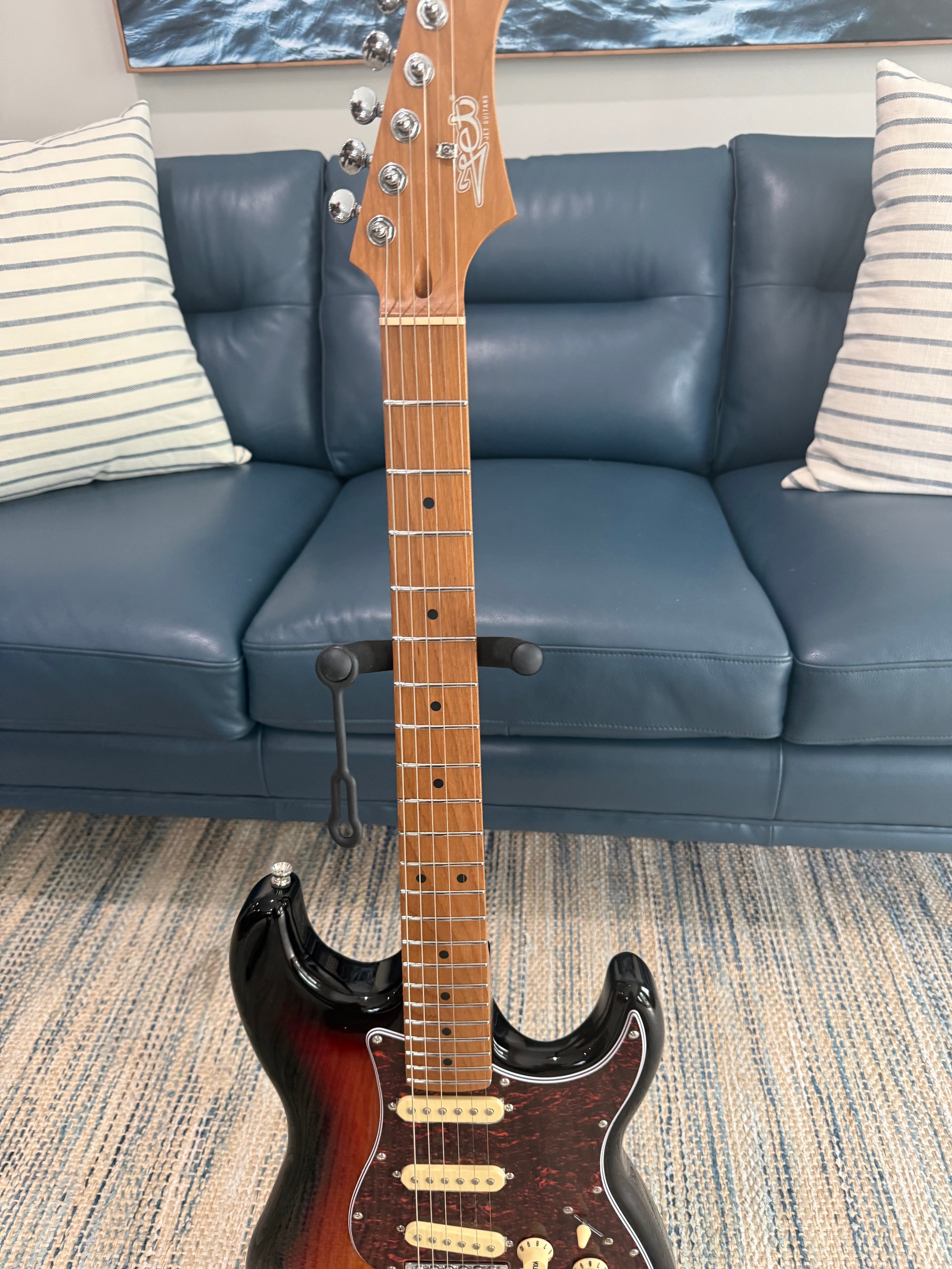 Palm Harbor Music JET JS-300 SB electric guitar with sunburst finish and chrome hardware, shown on a stand against a neutral background.