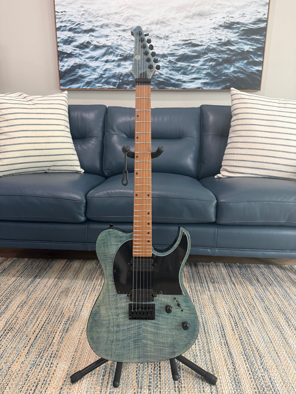 Spira T-450 TDB by Palm Harbor Music, a sleek black electric guitar with a modern design, shown with its body and neck visible.