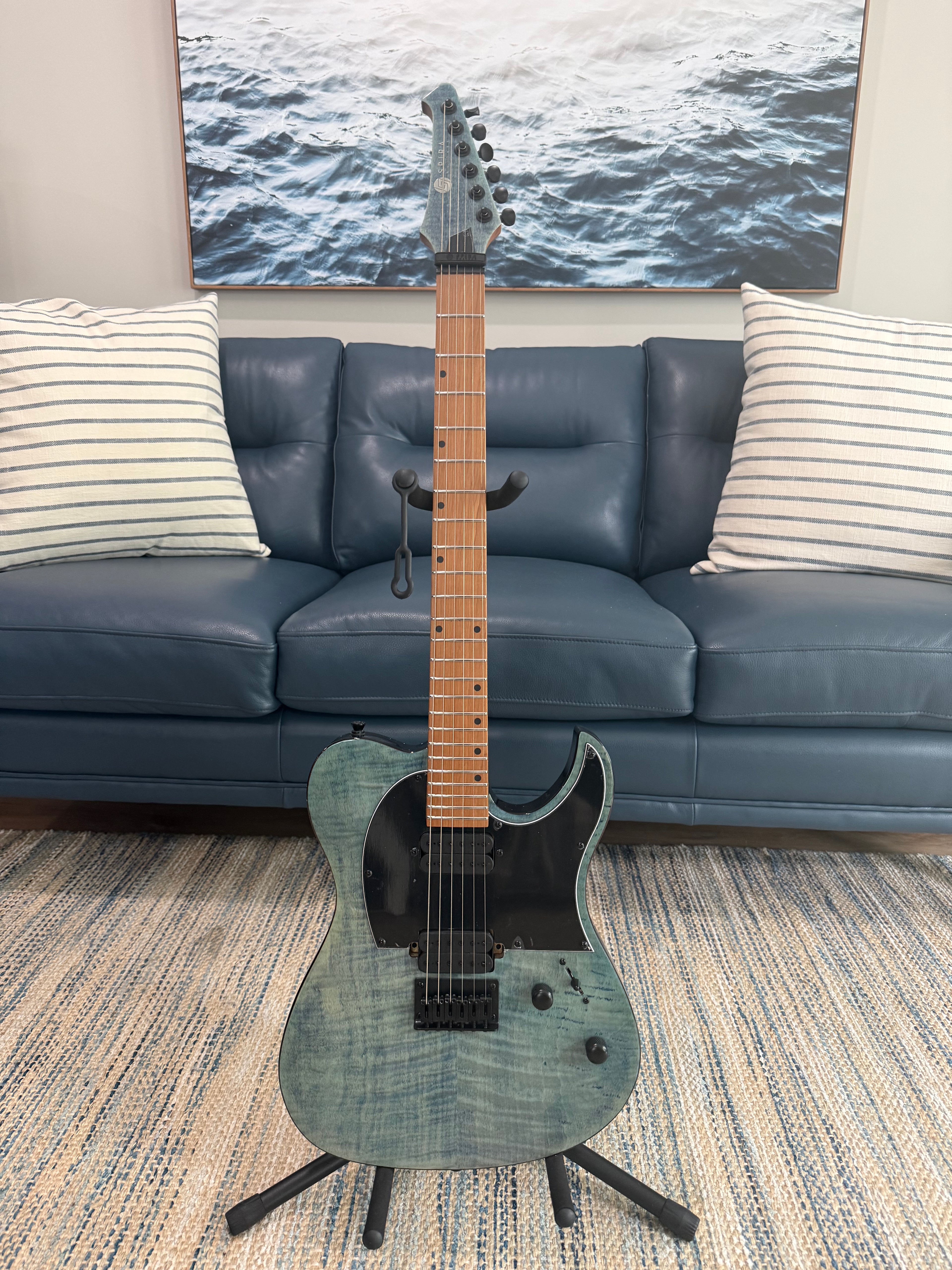 Spira T-450 TDB by Palm Harbor Music, a sleek black electric guitar with a modern design, shown with its body and neck visible.