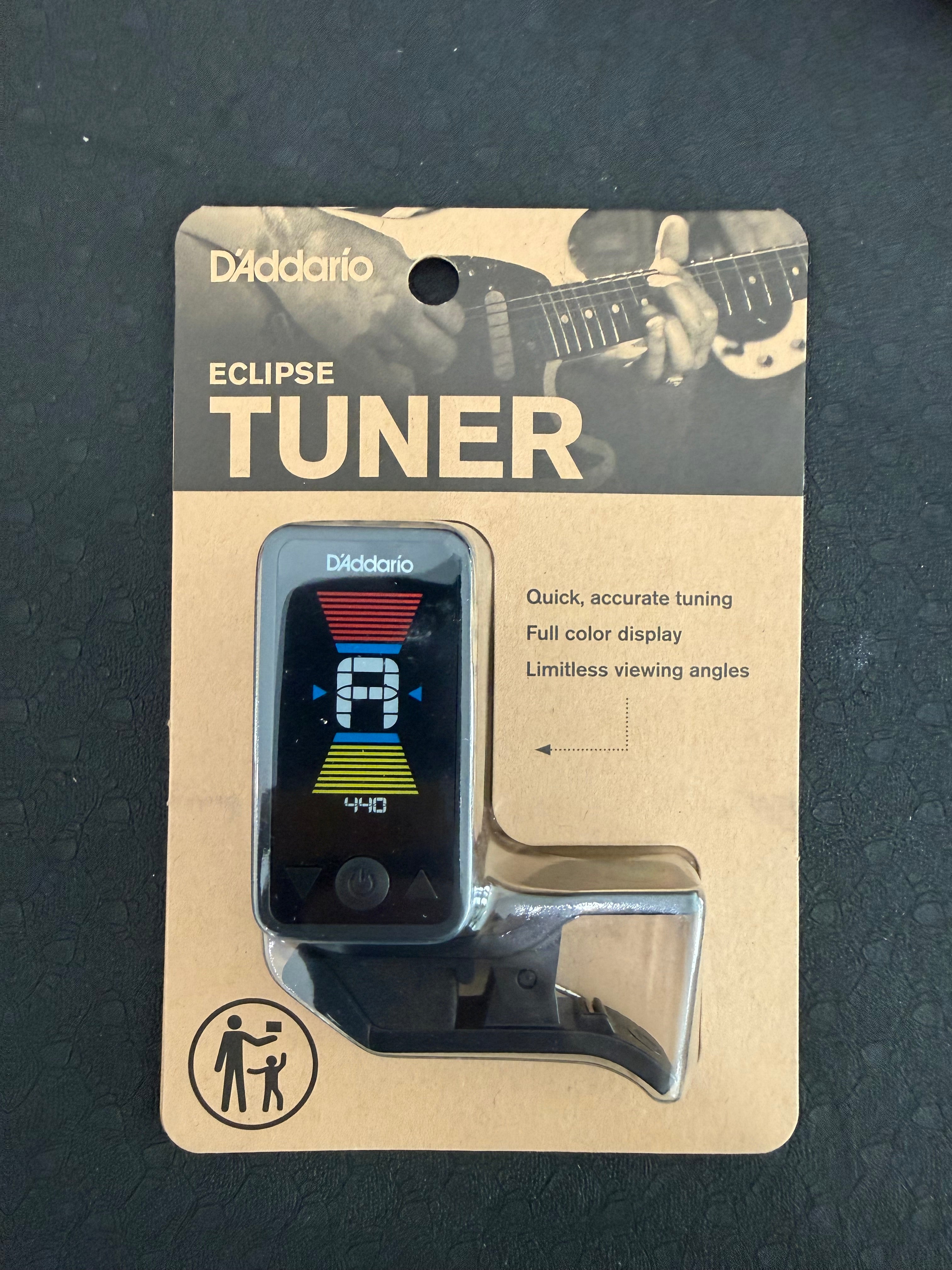 D’Addario Eclipse Headstock Tuner from Palm Harbor Music, showing a compact device attached to a guitar headstock for tuning.