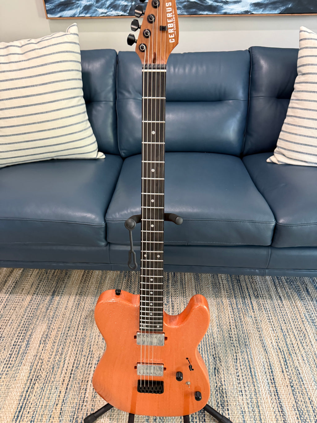 Cerberus Hermes 6HT Baritone saxophone in orange sparkle finish, showing the shiny body and detailed keys of the musical instrument.
