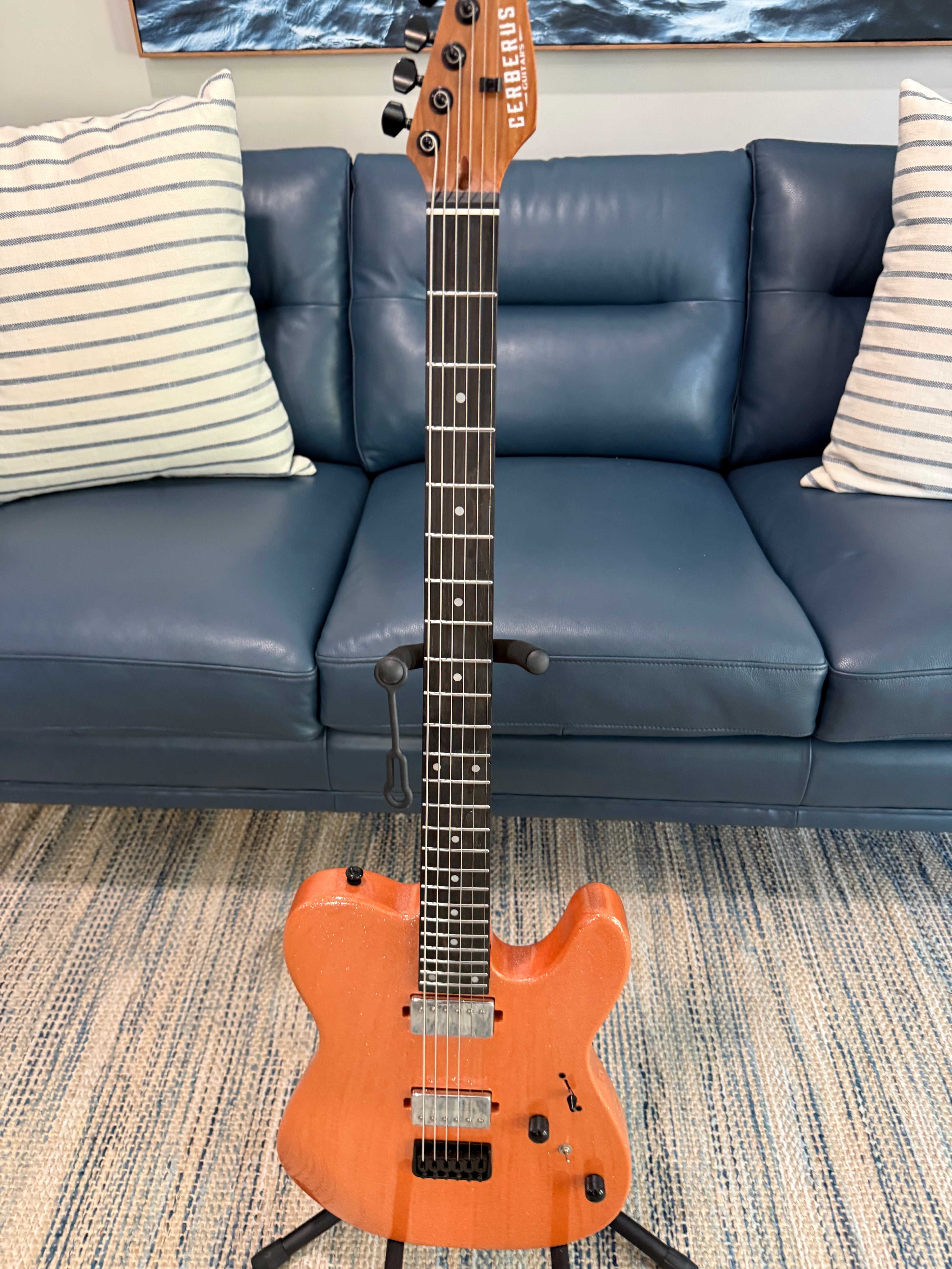 Cerberus Hermes 6HT Baritone saxophone in orange sparkle finish, showing the shiny body and detailed keys of the musical instrument.