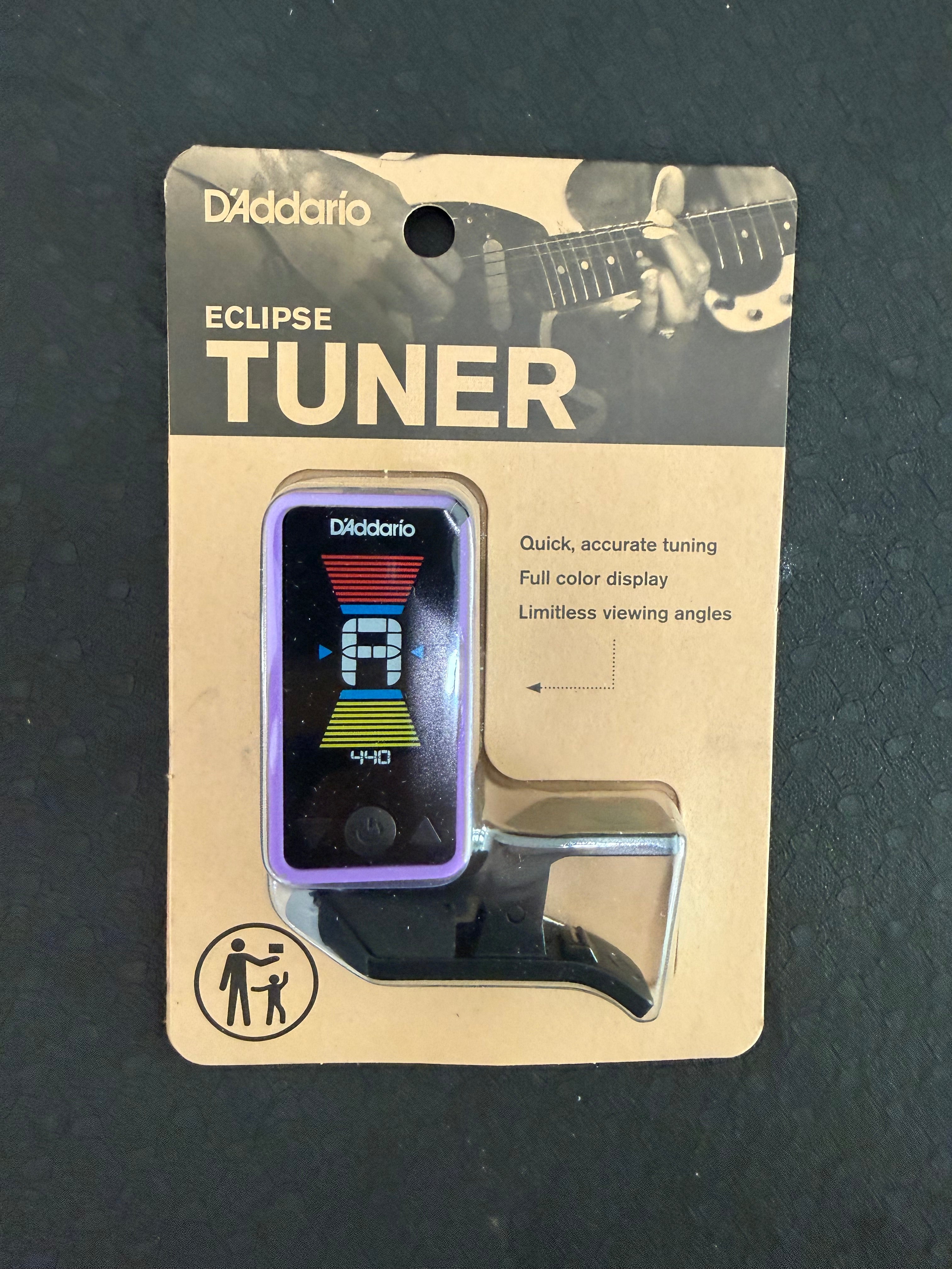 D'Addario Eclipse Headstock Tuner attached to a guitar headstock, showing its digital display and tuning pegs.