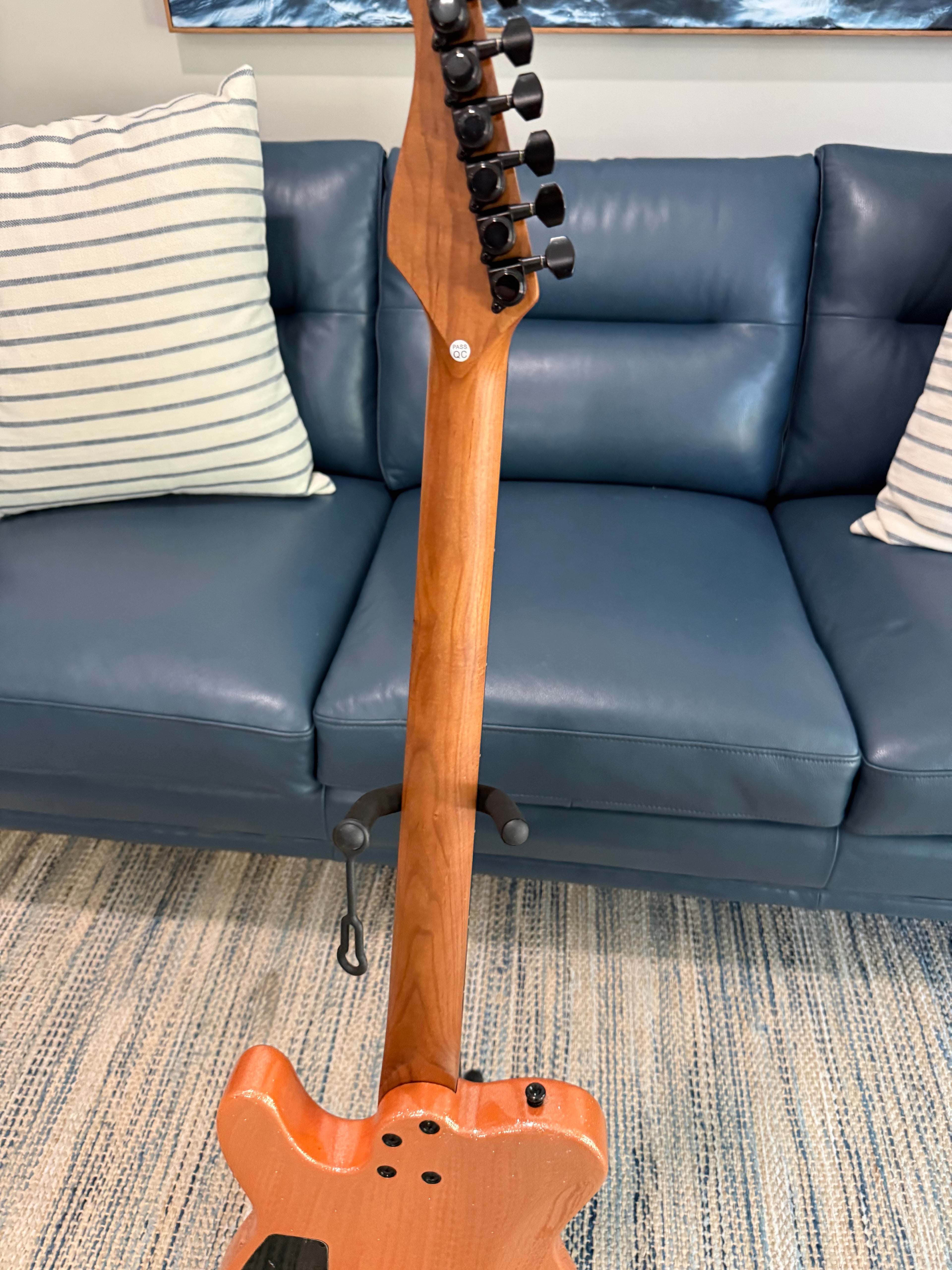 Cerberus Hermes 6HT Baritone saxophone in vibrant orange sparkle finish, showcasing the shiny, detailed brass instrument.