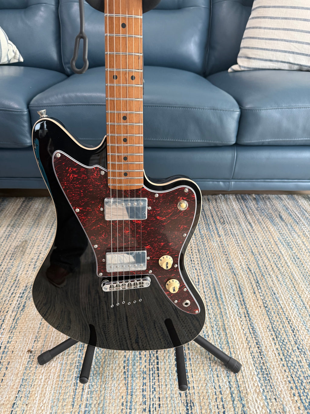Palm Harbor Music JET JJ-350 BK electric guitar with black finish, featuring a solid body and six strings, close-up view of the instrument.