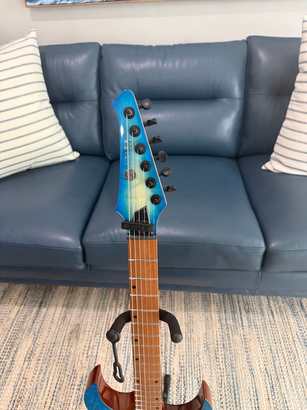 Palm Harbor Music Spira S-500 QAB acoustic guitar with natural wood finish and six strings, close-up of body and fretboard.