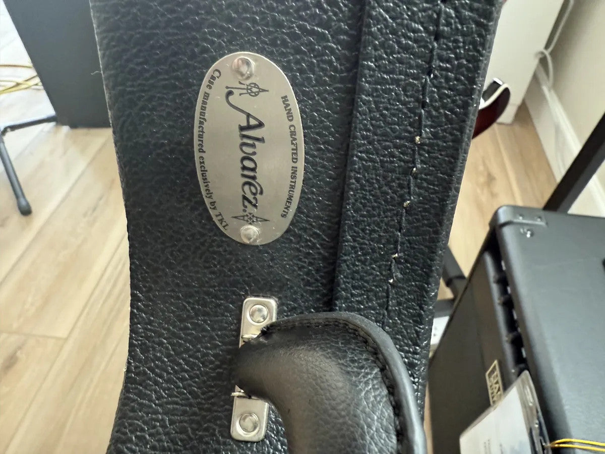 Used Alvarez hollow body electric guitar hardshell case with black exterior and plush interior padding.