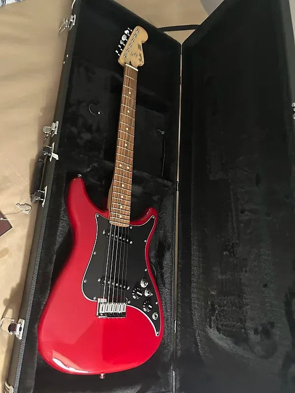 Fender Player Lead II guitar in crimson red transparent finish, showcasing a sleek body and classic design.