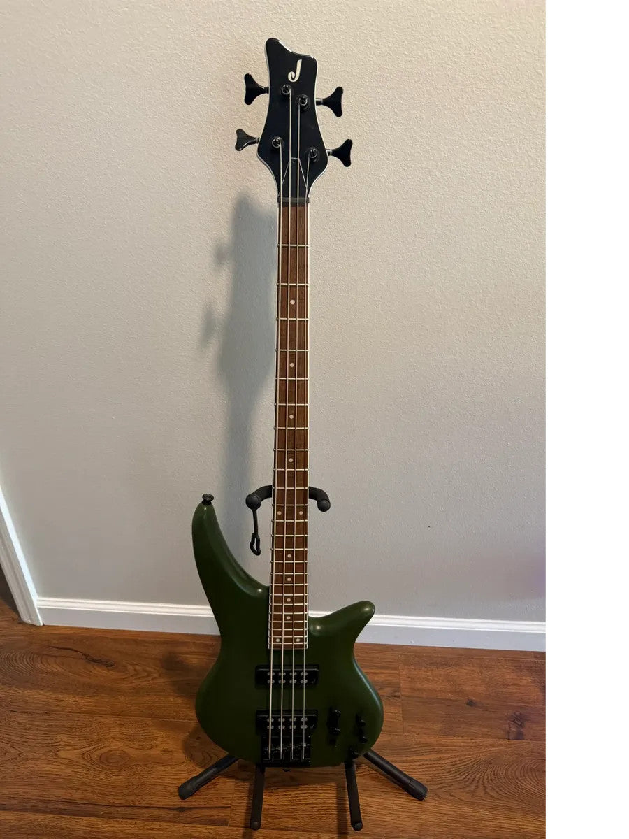 Used Jackson X Series Spectra Bass SBX IV in matte army drab with sleek body and four-string configuration.