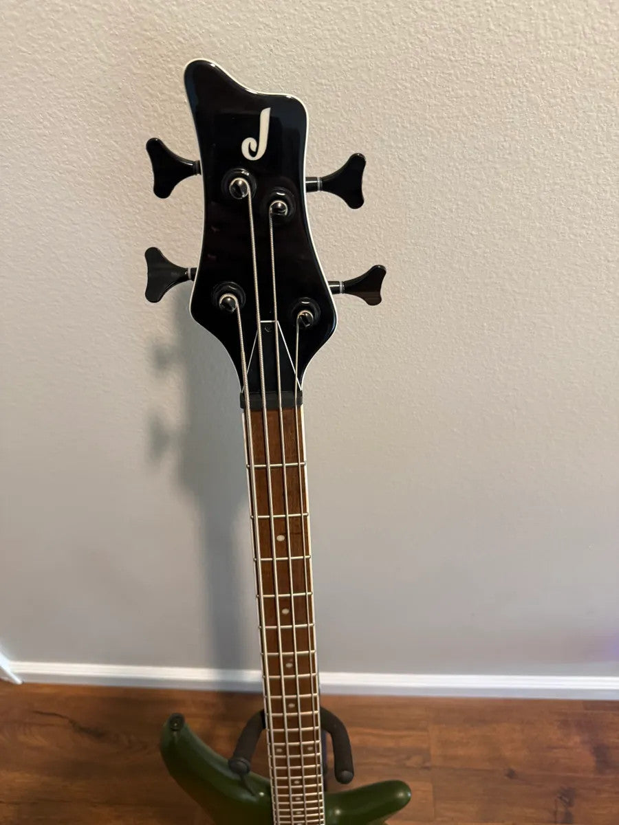 Used Jackson X Series Spectra Bass SBX IV in Matte Army Drab with four strings and sleek body design.