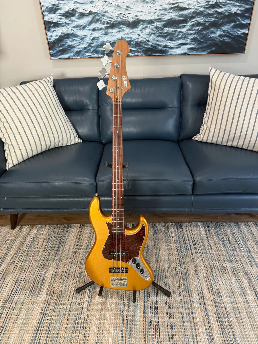 Jet Guitars JJB-300 GD R Bass in gold, showcasing its sleek body and stylish design with elegant hardware details.