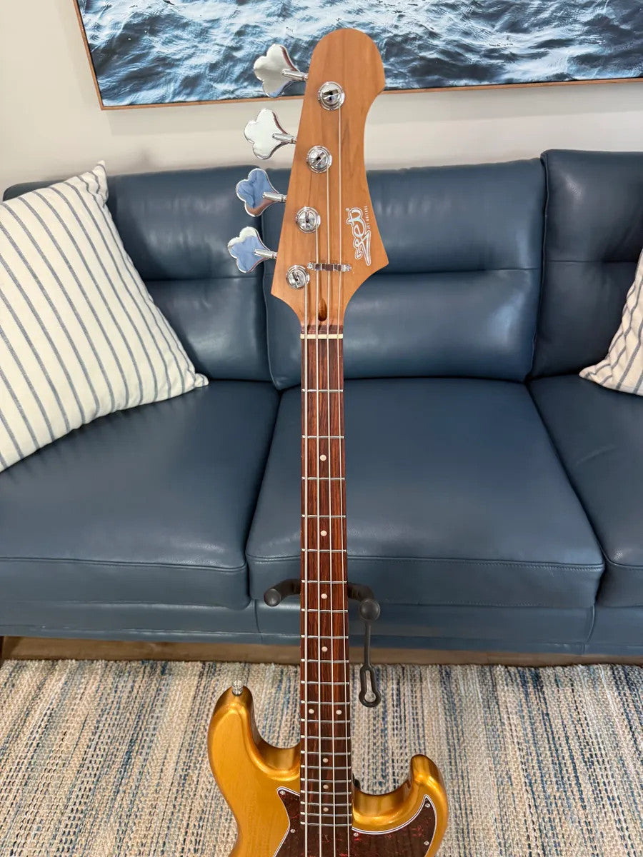 Jet Guitars JJB-300 GD R Bass with a sleek gold finish and elegant body shape, showcasing the fretboard and pickups.