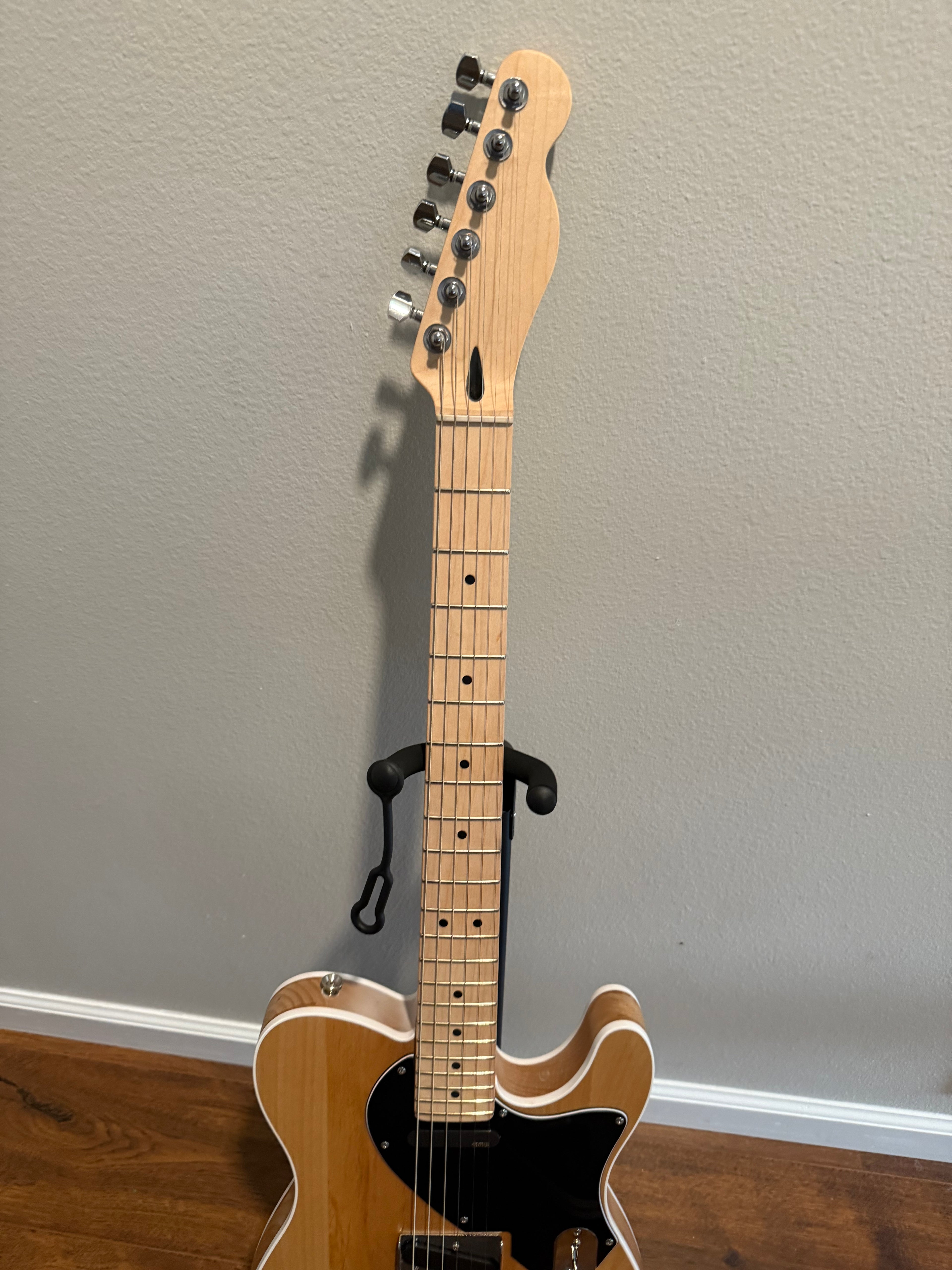 Custom Telecaster by Palm Harbor Music with a sunburst finish and vintage-style hardware against a wooden background.