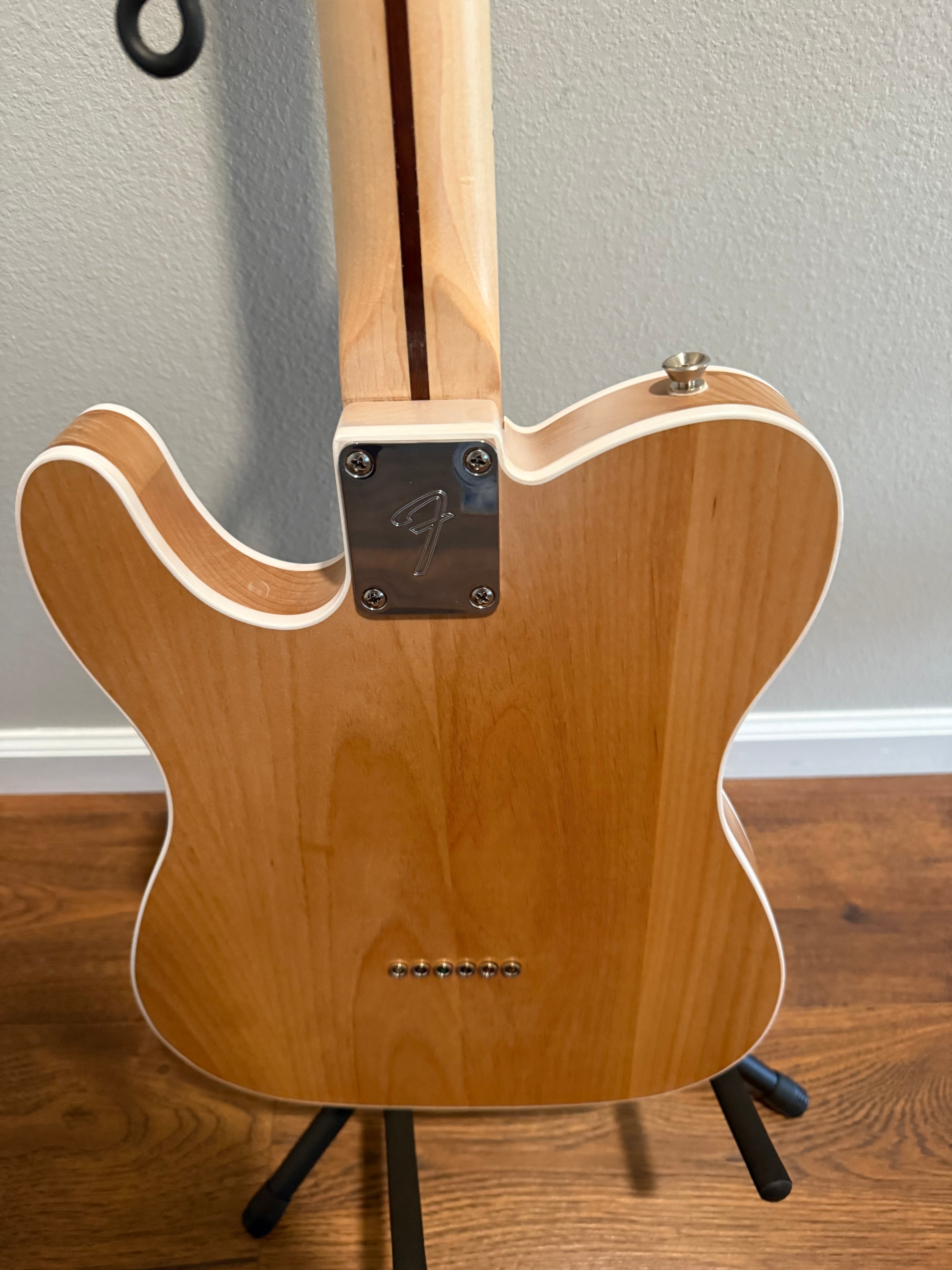 Custom Telecaster by Palm Harbor Music with a vibrant finish and unique design features against a neutral background.
