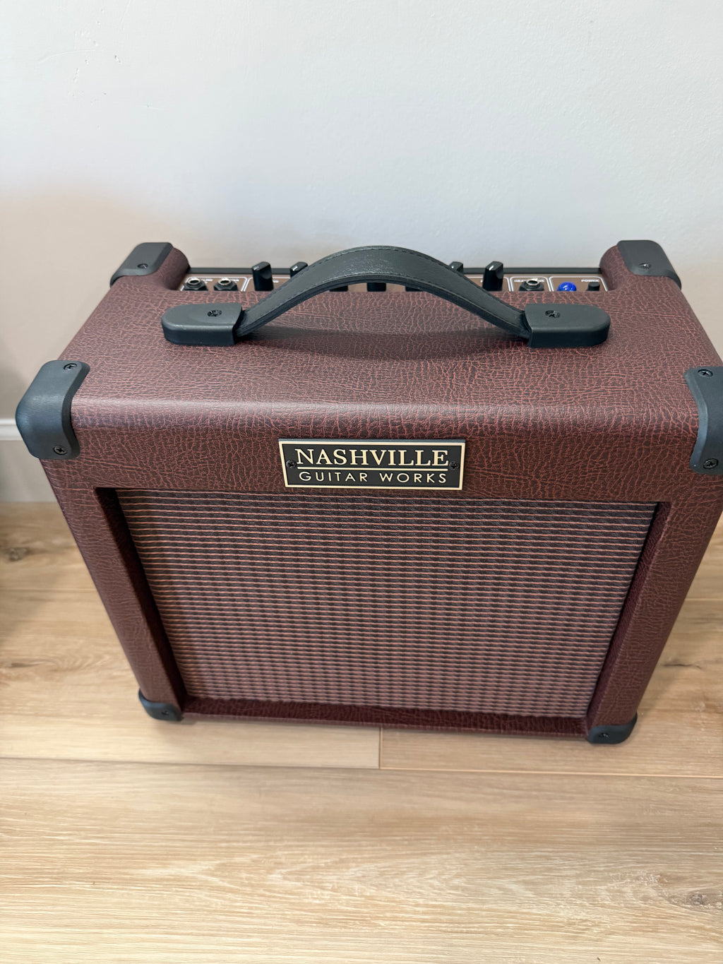 Palm Harbor Music NGW A15 acoustic amplifier with 8" speaker, 16 watts, and dual channels, showcasing its sleek design.