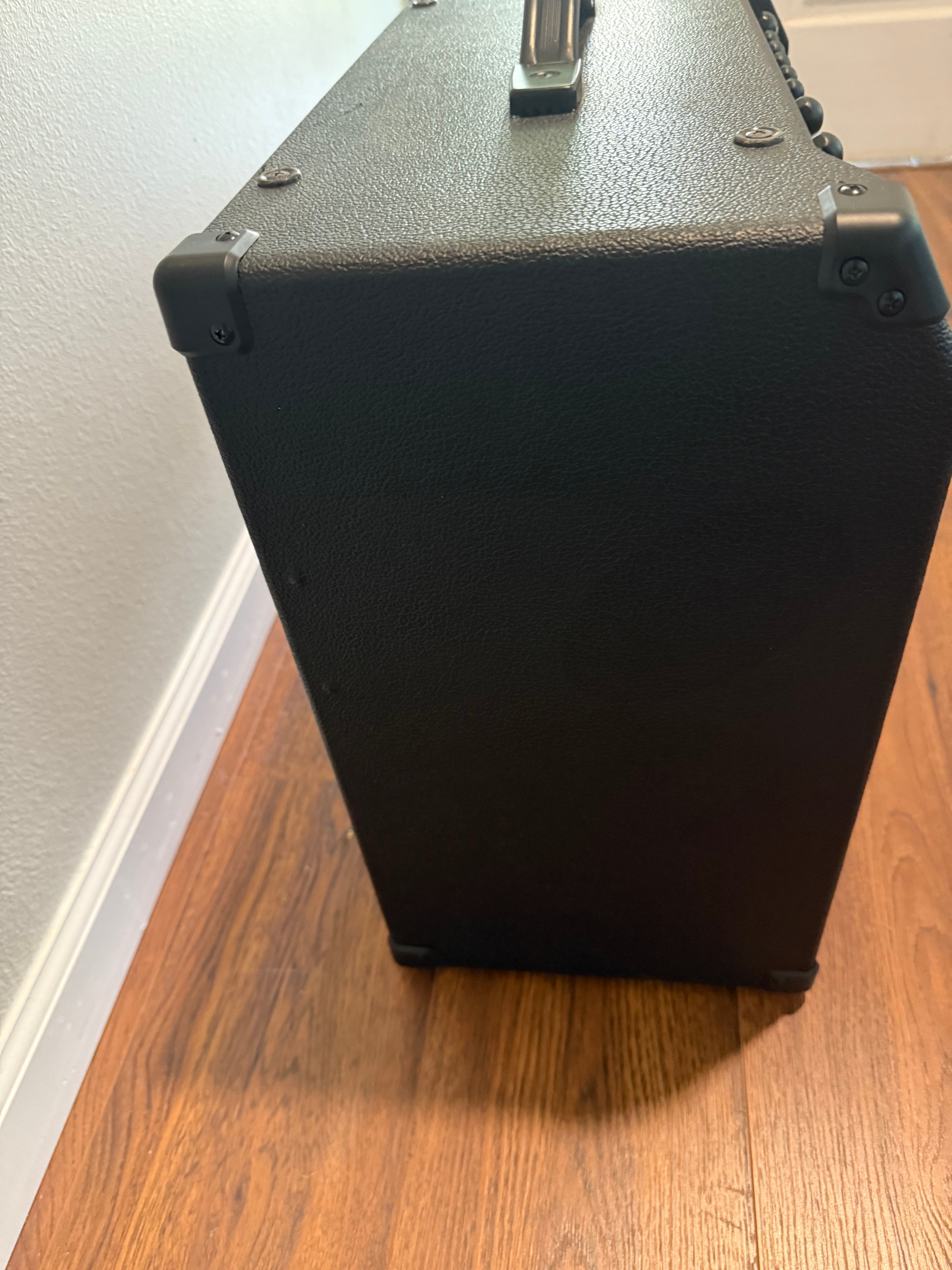 Peavey Max 115 1X15 bass combo amp in a sleek black design with control knobs and speaker grille visible.