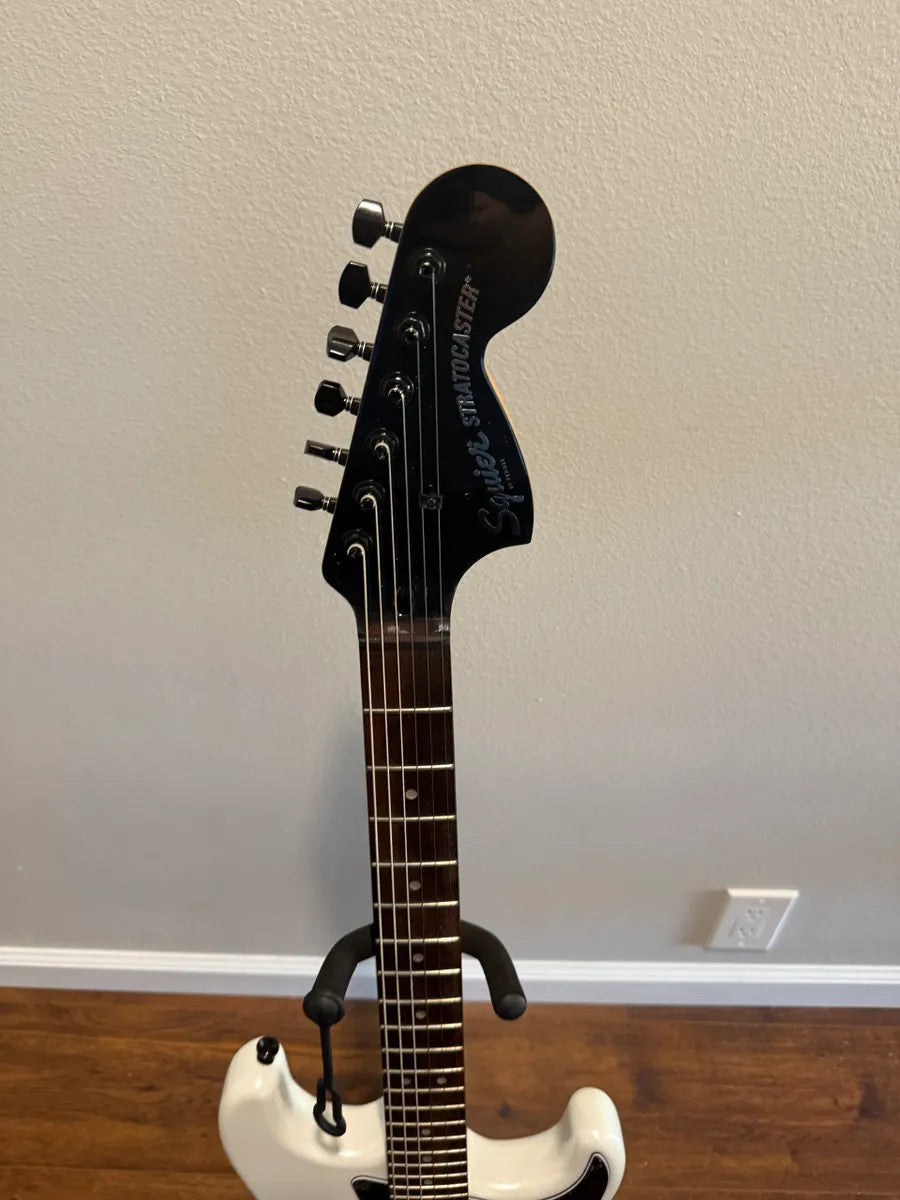 Used Squier Contemporary Stratocaster in pearl white finish with sleek body and classic Fender-inspired design.