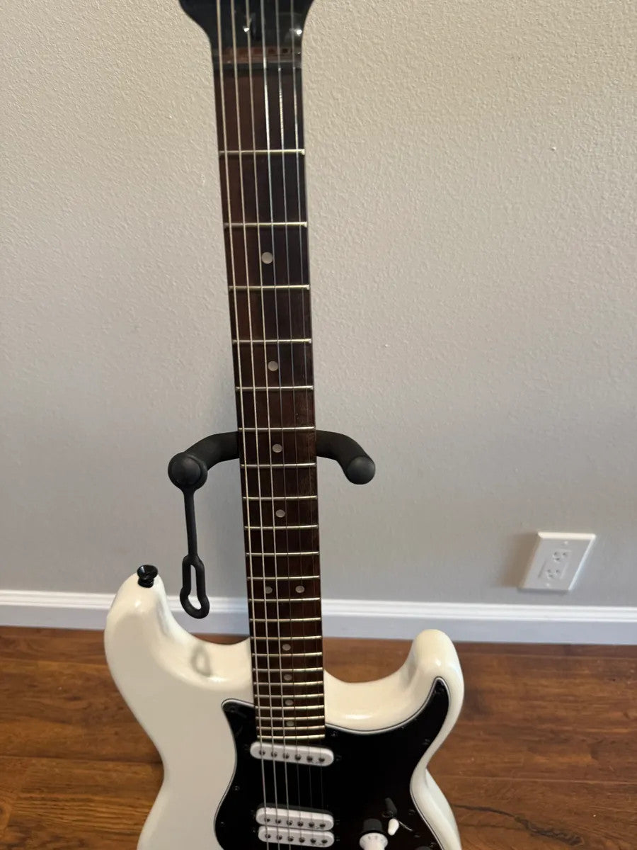 Used Squier Contemporary Stratocaster in pearl white finish, showcasing a sleek body and classic design features.