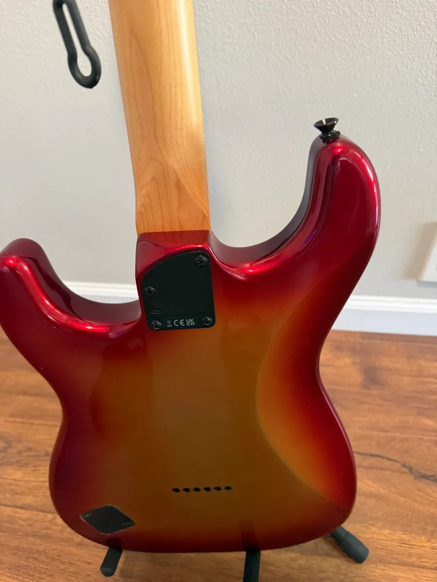 Used Squier Contemporary Stratocaster in Sunset Metallic finish, showcasing its sleek body and vibrant color.