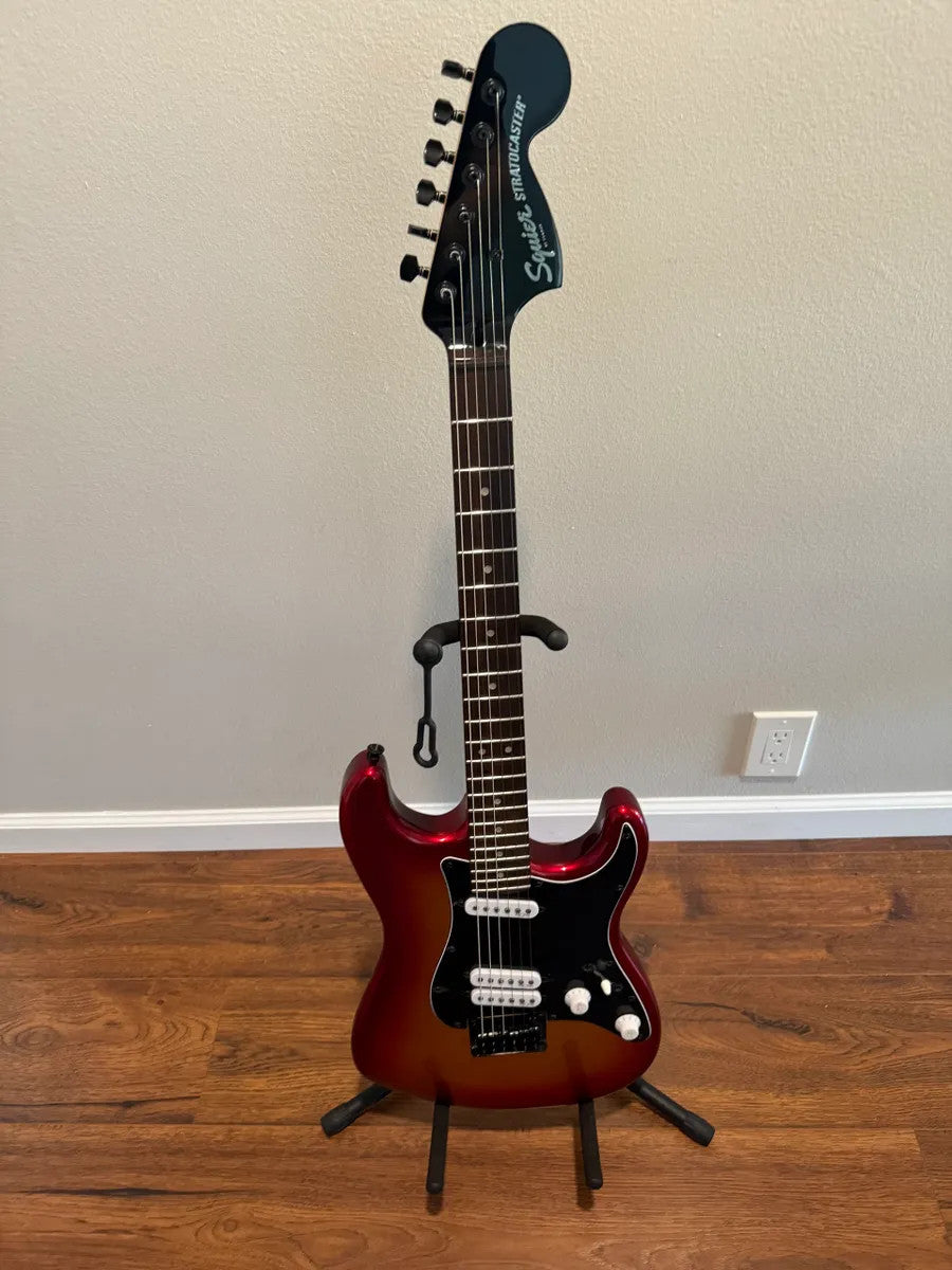 Used Squier Contemporary Stratocaster in Sunset Metallic finish, showcasing its vibrant color and sleek design.