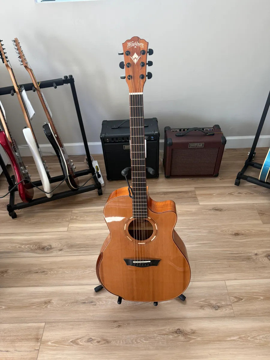 Used Washburn Comfort Series WCG66SCE acoustic electric guitar with a natural finish and cutaway body design.