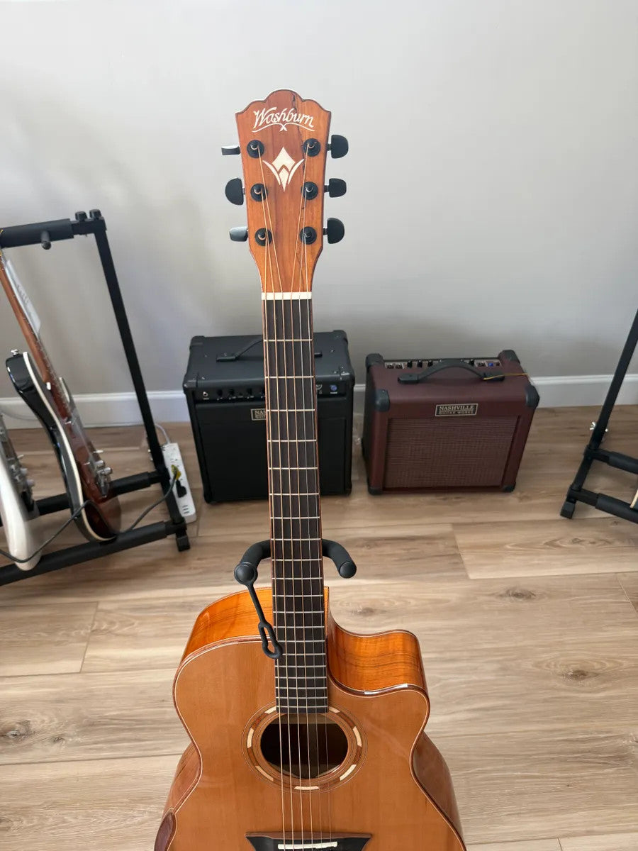 Used Washburn Comfort Series WCG66SCE acoustic electric guitar with a natural wood finish and cutaway body design.