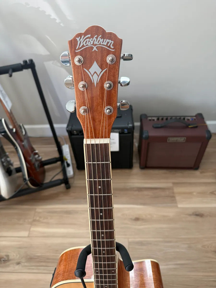 Used Washburn Dreadnaught WD7SCE acoustic electric guitar with a natural wood finish and cutaway design.
