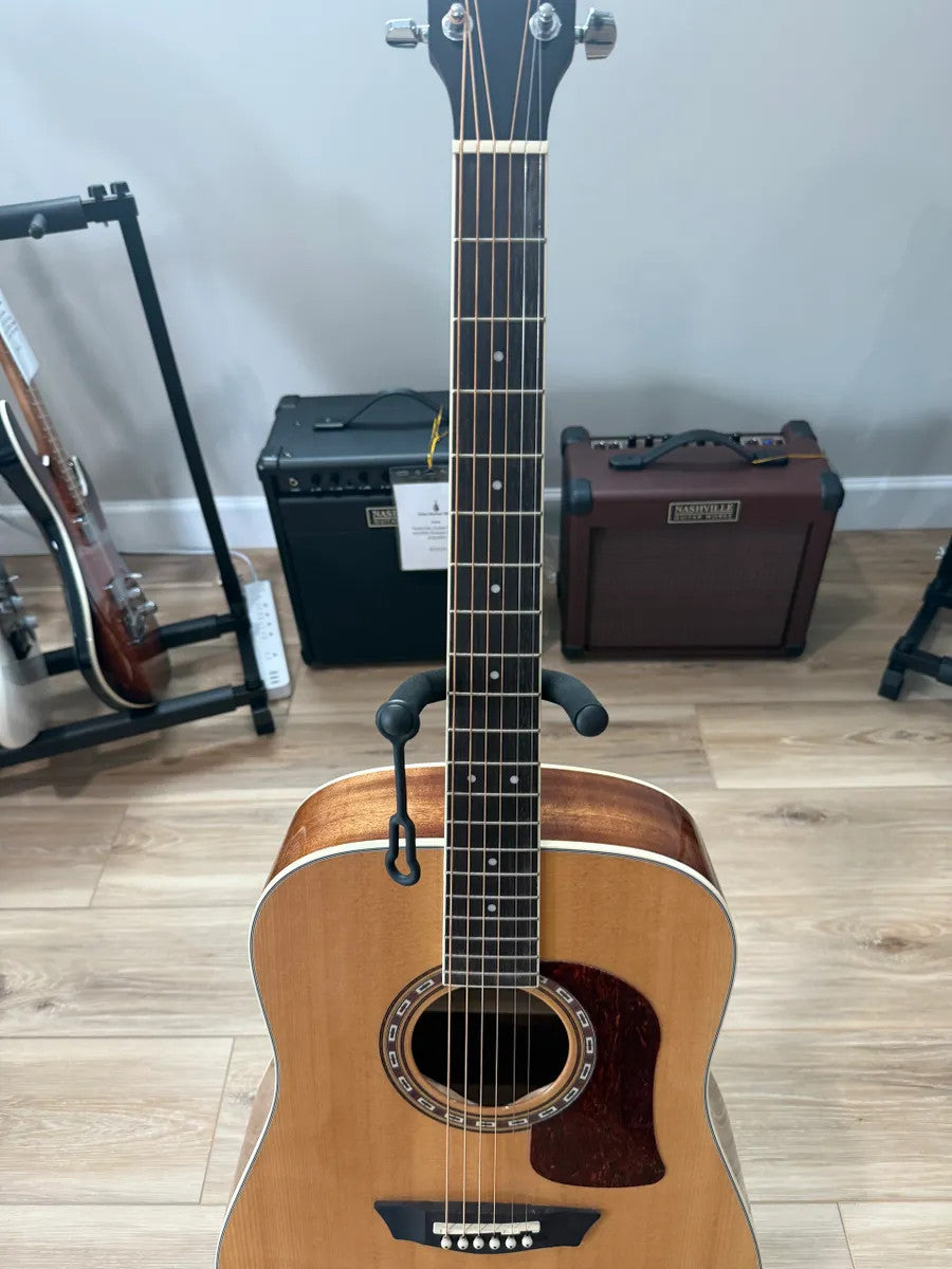 Used Washburn HD10S Heritage Acoustic Guitar with a natural wood finish and classic shape, showcasing its elegant design.
