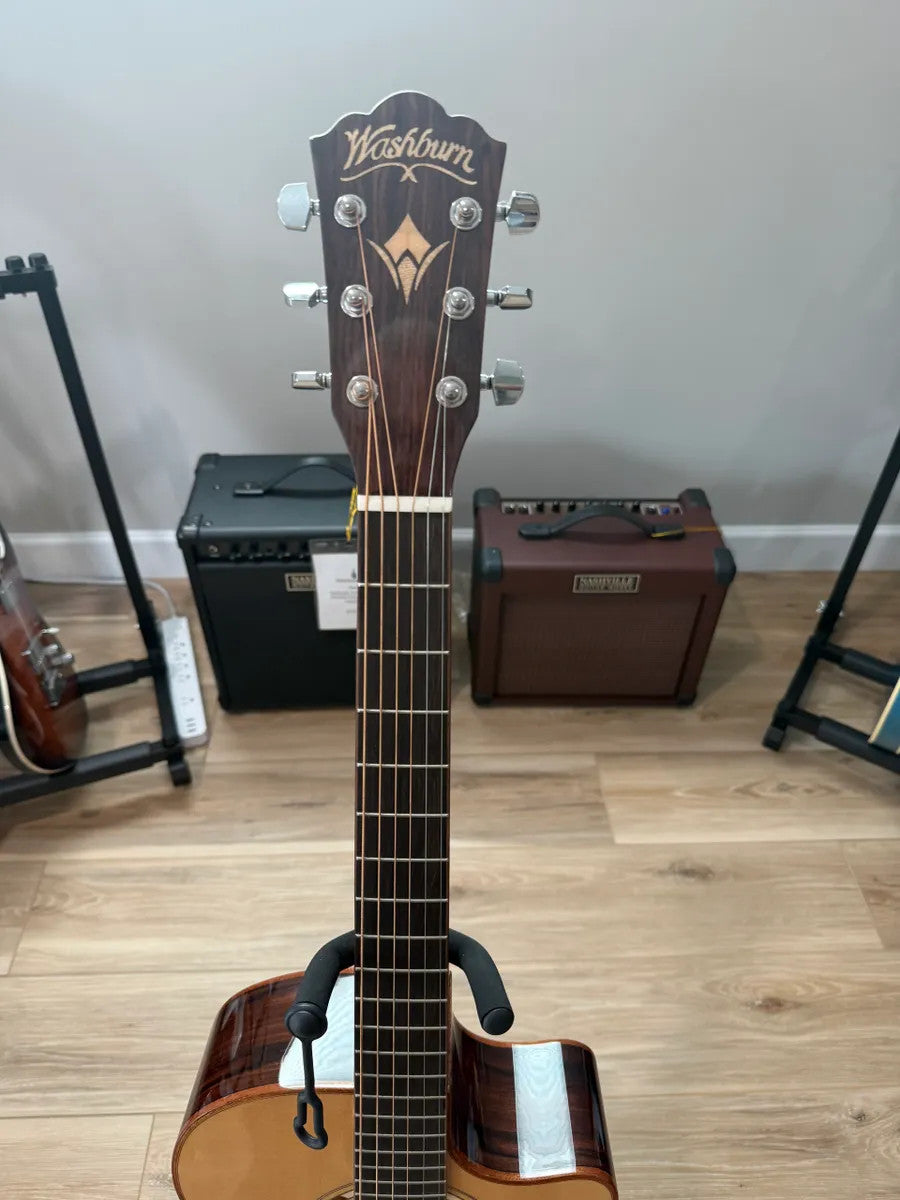 Used Washburn WCG20SCE Comfort Acoustic Electric Guitar with a natural wood finish and smooth body shape.