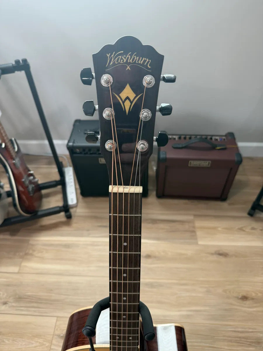 Used Washburn WLO20SCE Woodline acoustic electric guitar showcasing its sleek body and rich wood grain detail.